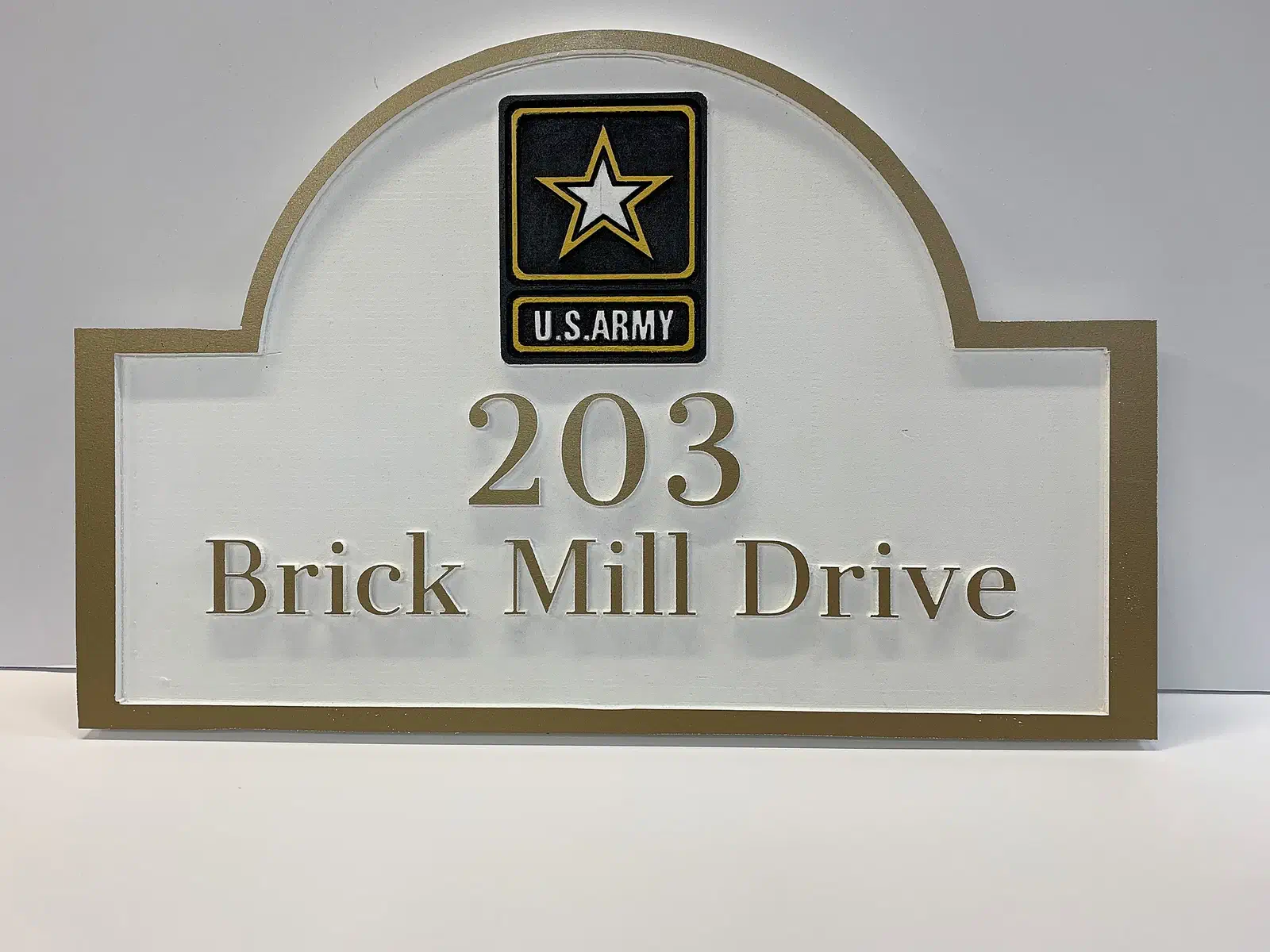 Finished white and bronze arched address plaque with 203 Brick Mill Drive lettering and a removable Army emblem