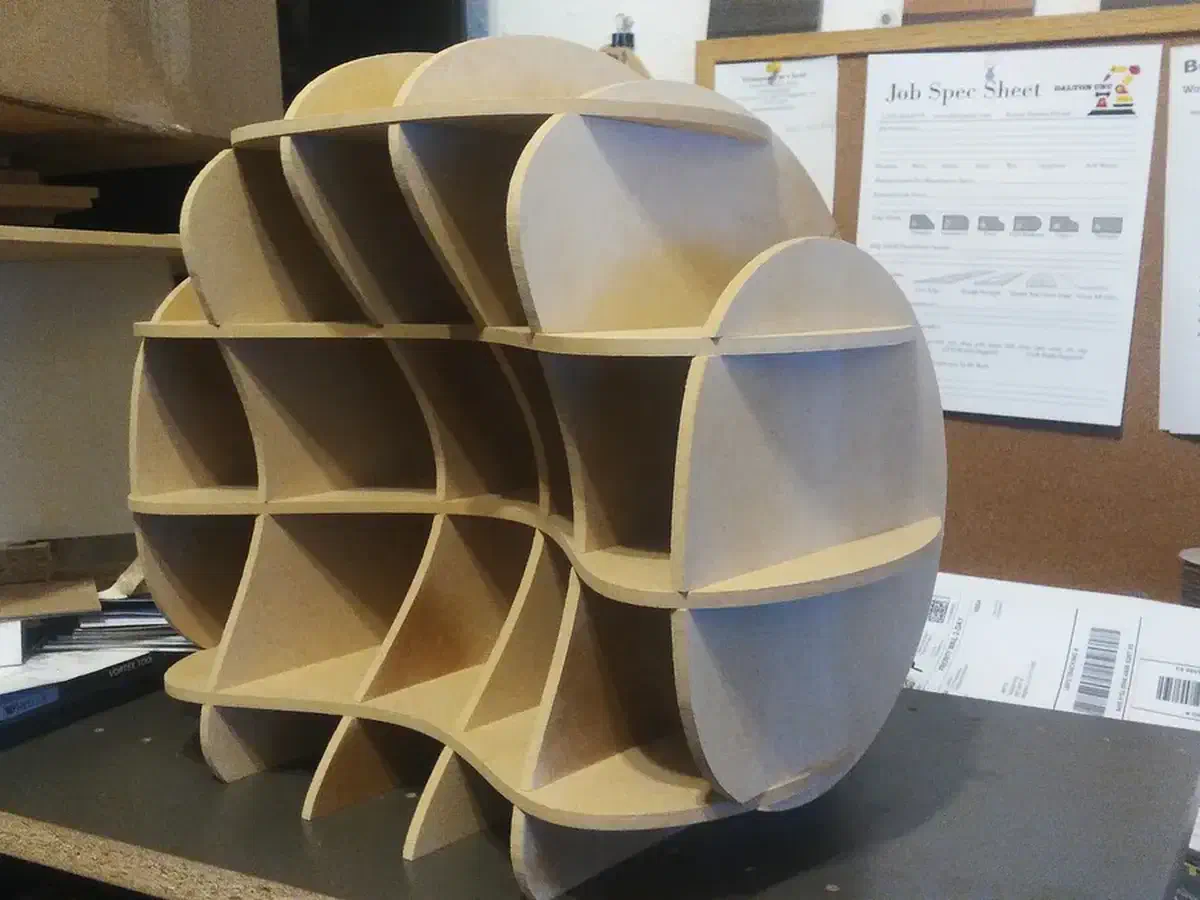 Finished circular cubby assembled from intersecting wooden sheet ribs