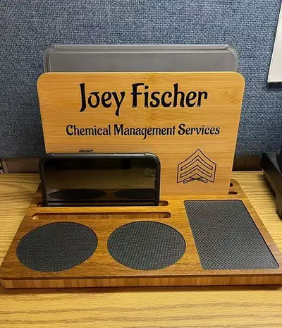 Finished bamboo desk organizer with an upright personalized panel and black circular and rectangular liners