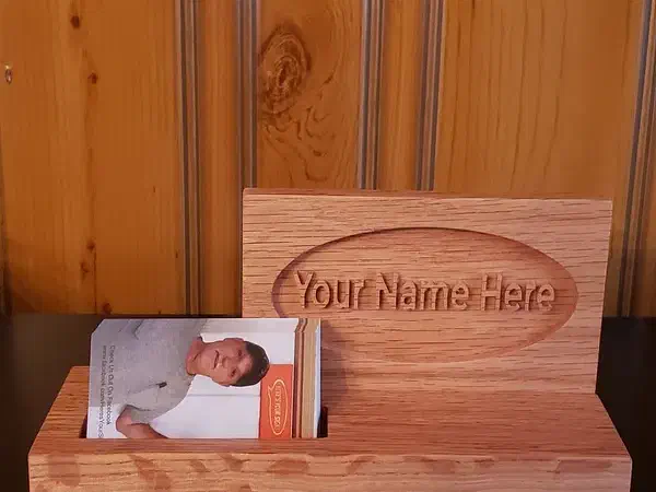 Finished wooden upright nameplate and business-card holder with cards in the front slot