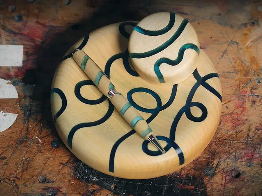 Finished wooden bowl form, pen, and rounded night light cap with curved green epoxy inlays