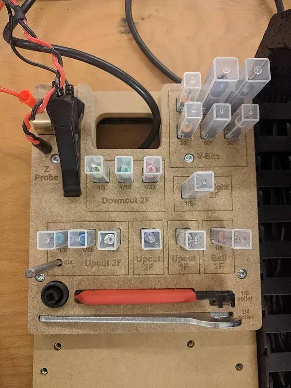 MDF sideboard organizer with labeled bit cases, probe, wrench and red-handled tool