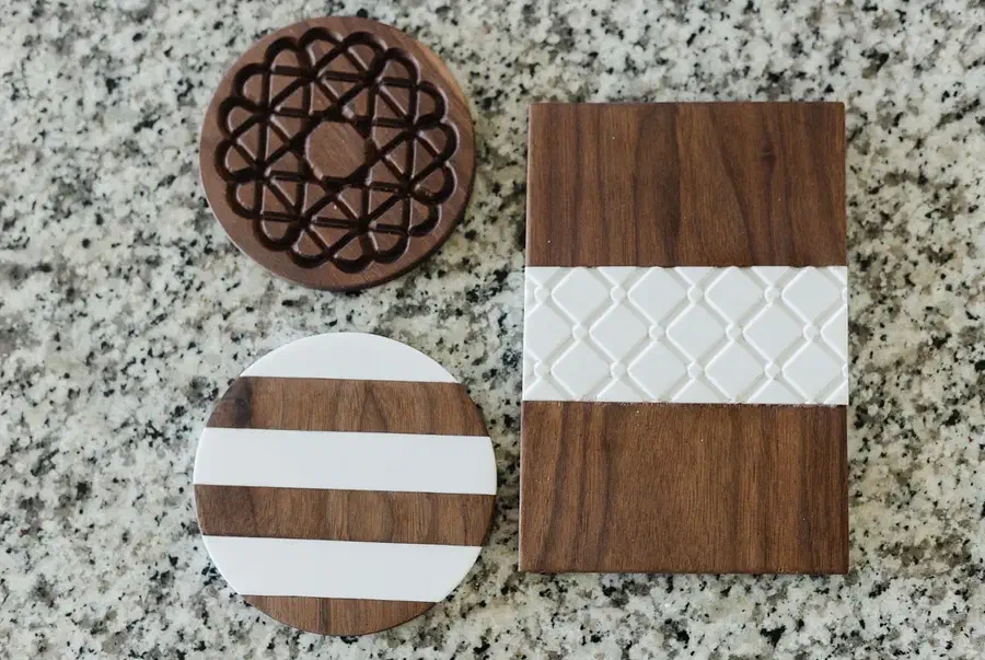Round and rectangular trivets made from dark walnut and pale patterned Corian