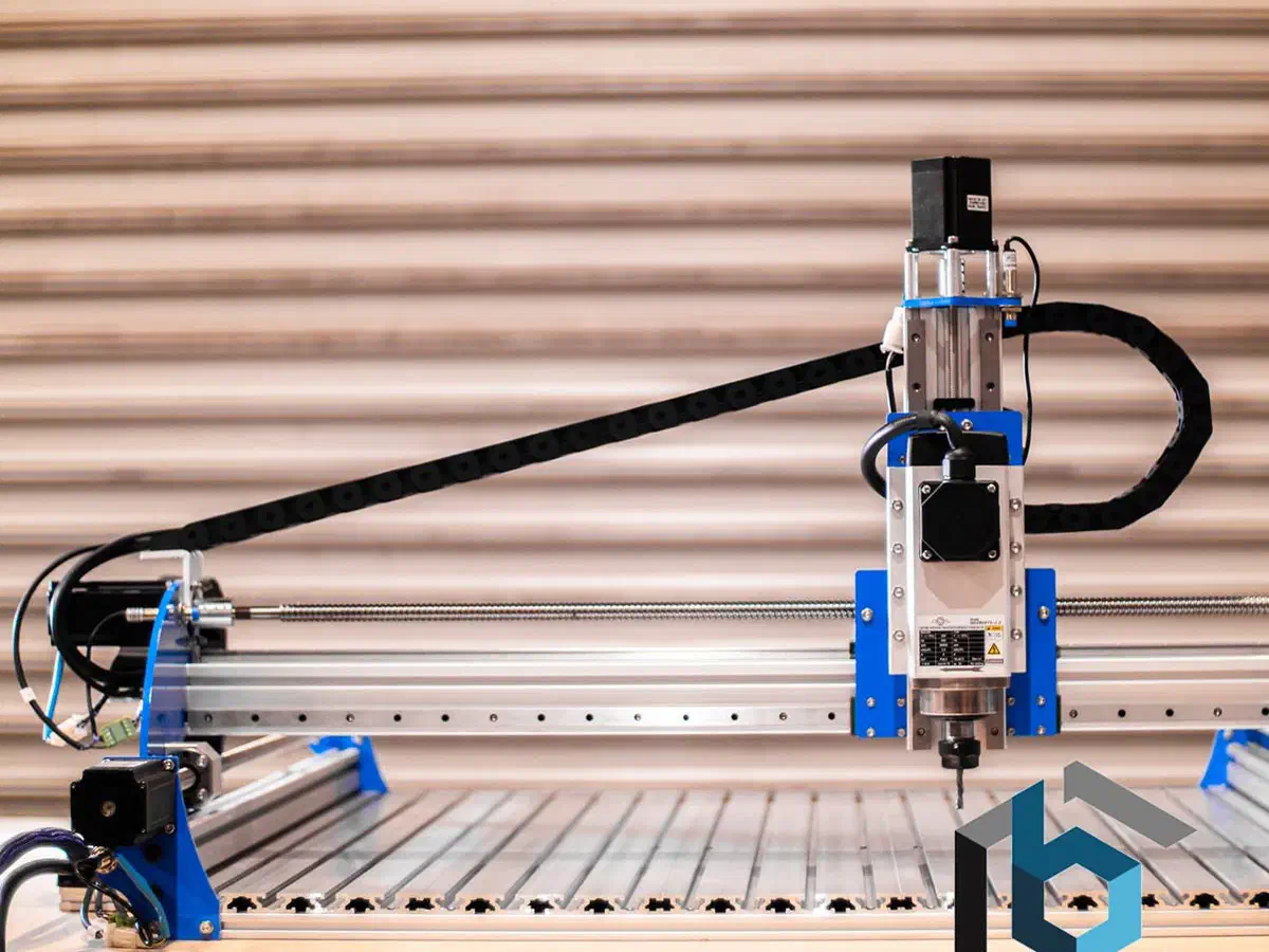 A BlueCarve Turbo CNC router with a blue gantry on a slatted bed.